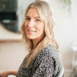 Lifestyle portrait of a woman with blonde hair in a salon, capturing natural beauty.