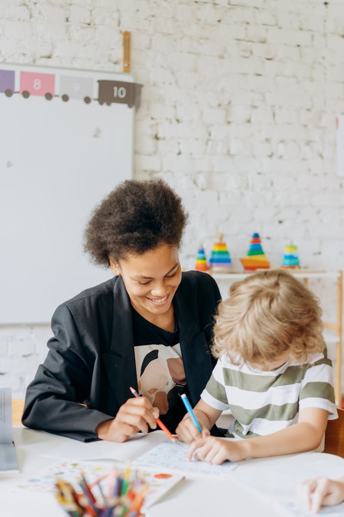 What If Behavior Is a Message, Not a Problem? A teacher and a child engaging in a learning activity in a bright, colorful classroom.